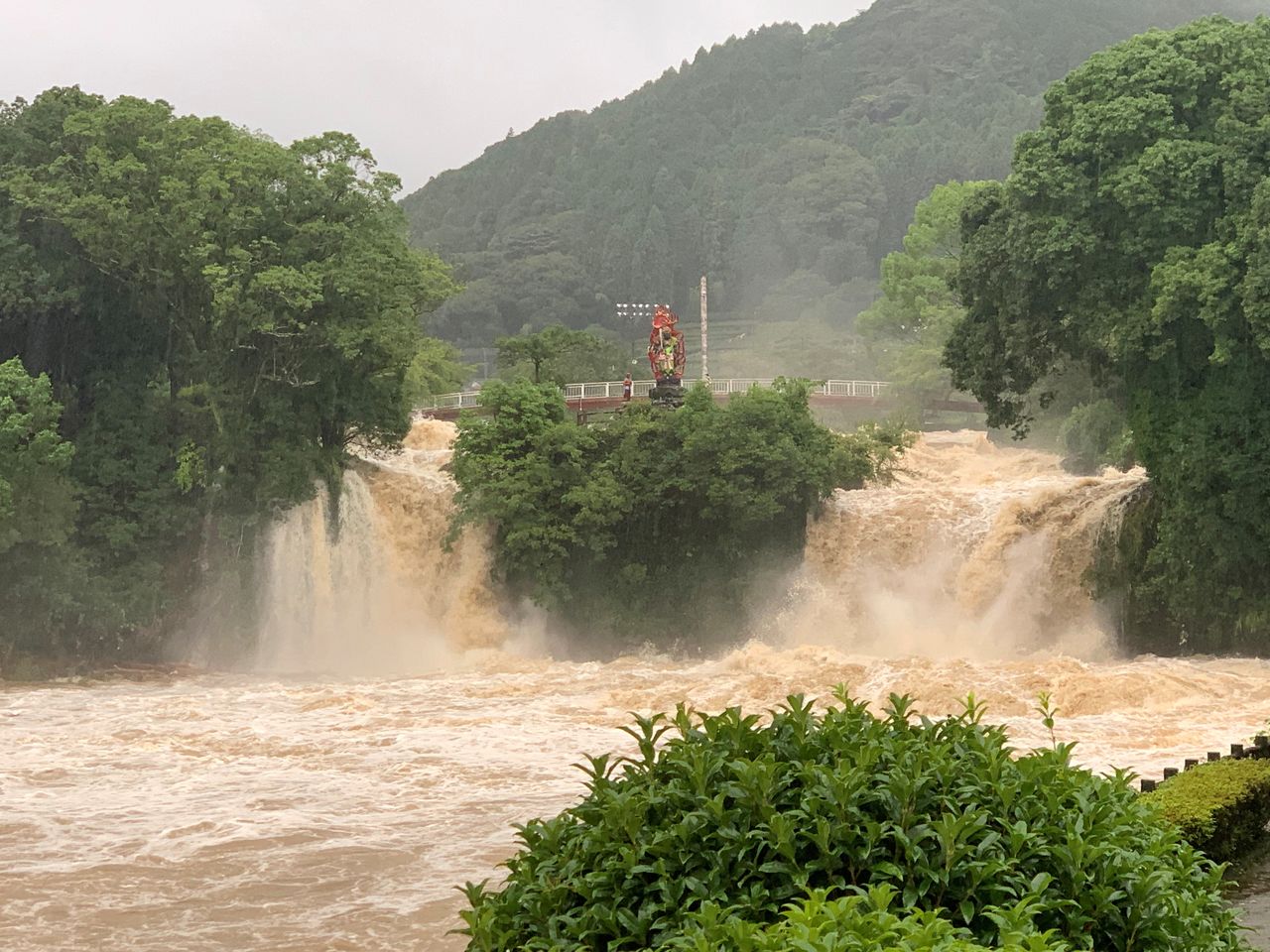 A general view shows muddy water during floods at Todorokinotaki water park in Ureshino city, Saga Prefecture, Japan August 14, 2021, in this picture obtained from social media. Mandatory credit TWITTER @KONOEMON321/via REUTERS