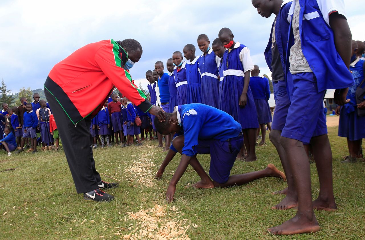 Steeplechase coach Boniface Tiren trains a pupils at Chesubet Primary school during a steeplechase exercise session, in Marakwet East of Elgeyo-Marakwet County Kenya August 6, 2021. REUTERS/Monicah Mwangi