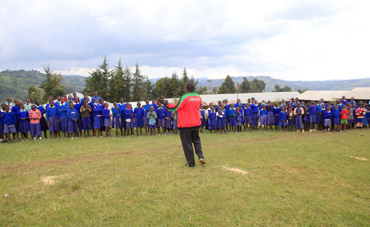 Steeplechase coach Boniface Tiren speaks to pupils at the Chesubet Primary school during a steeplechase exercise session, in Marakwet East of Elgeyo-Marakwet County, Kenya August 6, 2021. REUTERS/Monicah Mwangi