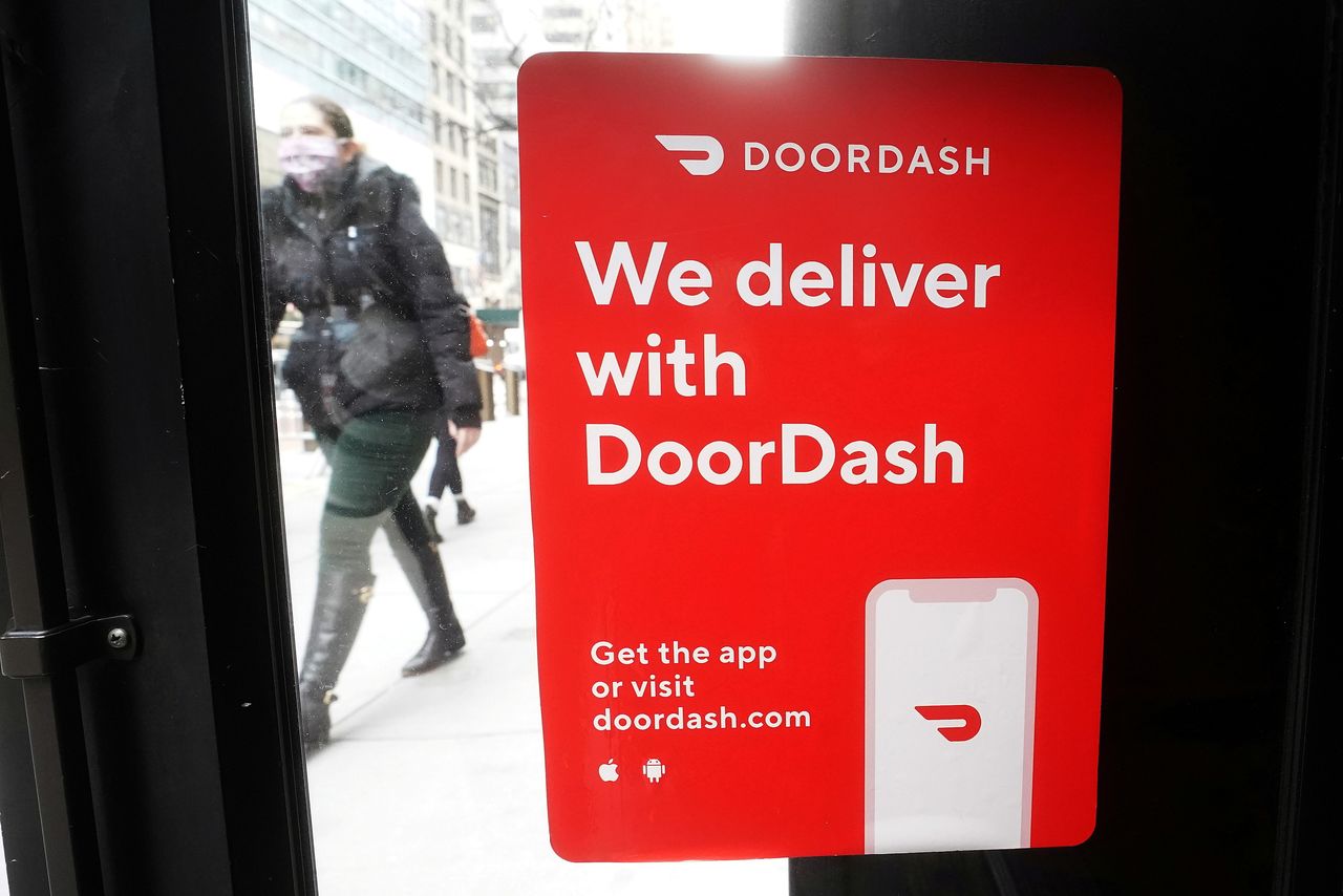 FILE PHOTO: FILE PHOTO: A DoorDash sign is pictured on a restaurant in the Manhattan borough of New York City, New York, U.S., December 9, 2020. REUTERS/Carlo Allegri