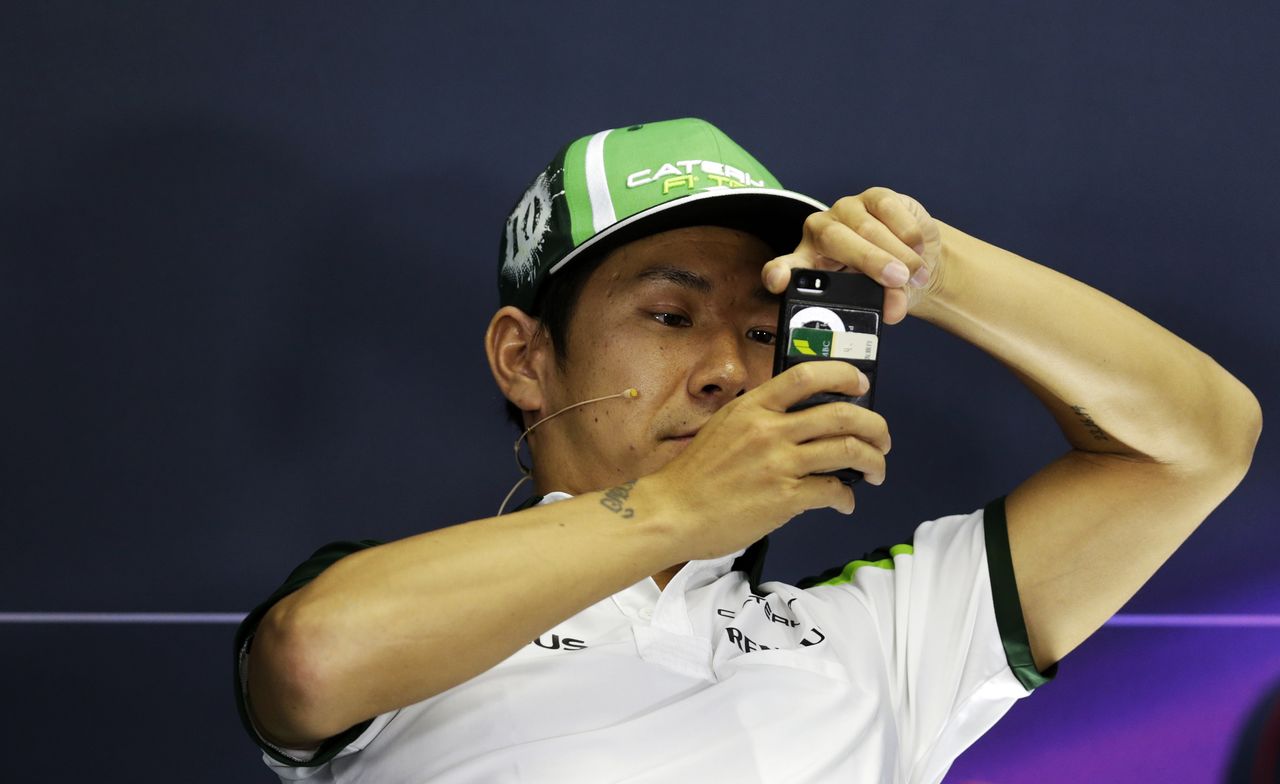 FILE PHOTO: Caterham Formula One driver Kamui Kobayashi of Japan takes a picture during a news conference at the Hungaroring circuit, near Budapest July 24, 2014. Hungarian Grand Prix will take place on Sunday July 27. REUTERS/David W Cerny