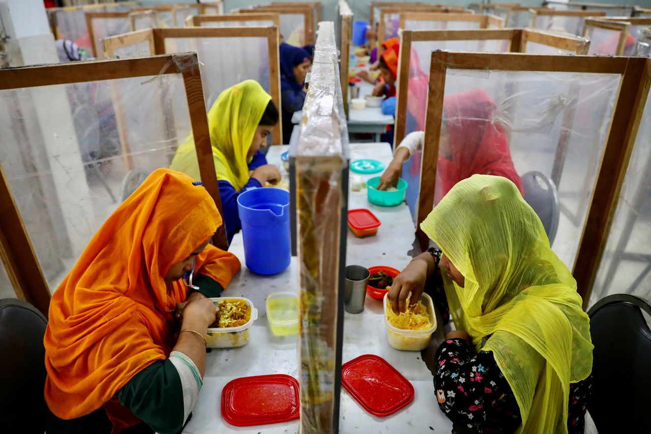 Employees dine between polythene sheets, as a safety measure to reduce the spread of coronavirus disease (COVID-19), at The Civil Engineering Limited garment factory in Dhaka, Bangladesh, August 17, 2021. REUTERS/Mohammad Ponir Hossain
