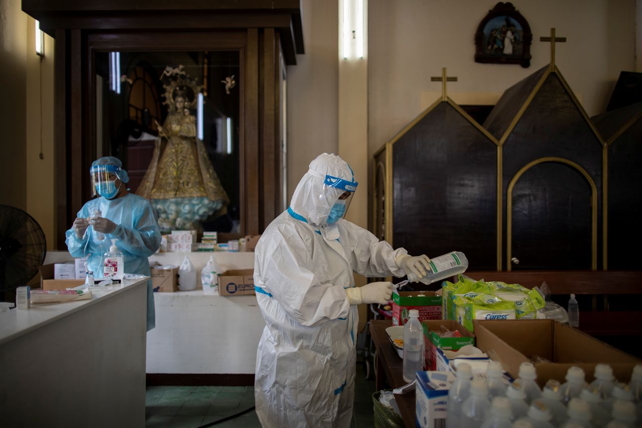 Health workers prepare to treat coronavirus disease (COVID-19) patients admitted in the chapel of Quezon City General Hospital turned into a COVID-19 ward amid rising infections, in Quezon City, Metro Manila, Philippines, August 20, 2021. REUTERS/Eloisa Lopez