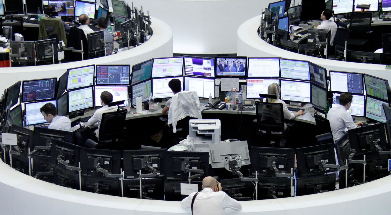 FILE PHOTO: A photographer takes pictures of traders before the opening of the German stock exchange in front of the empty DAX board, at the stock exchange in Frankfurt, Germany, June 24, 2016 after Britain voted to leave the European Union in the EU BREXIT referendum. REUTERS/Staff/Remote