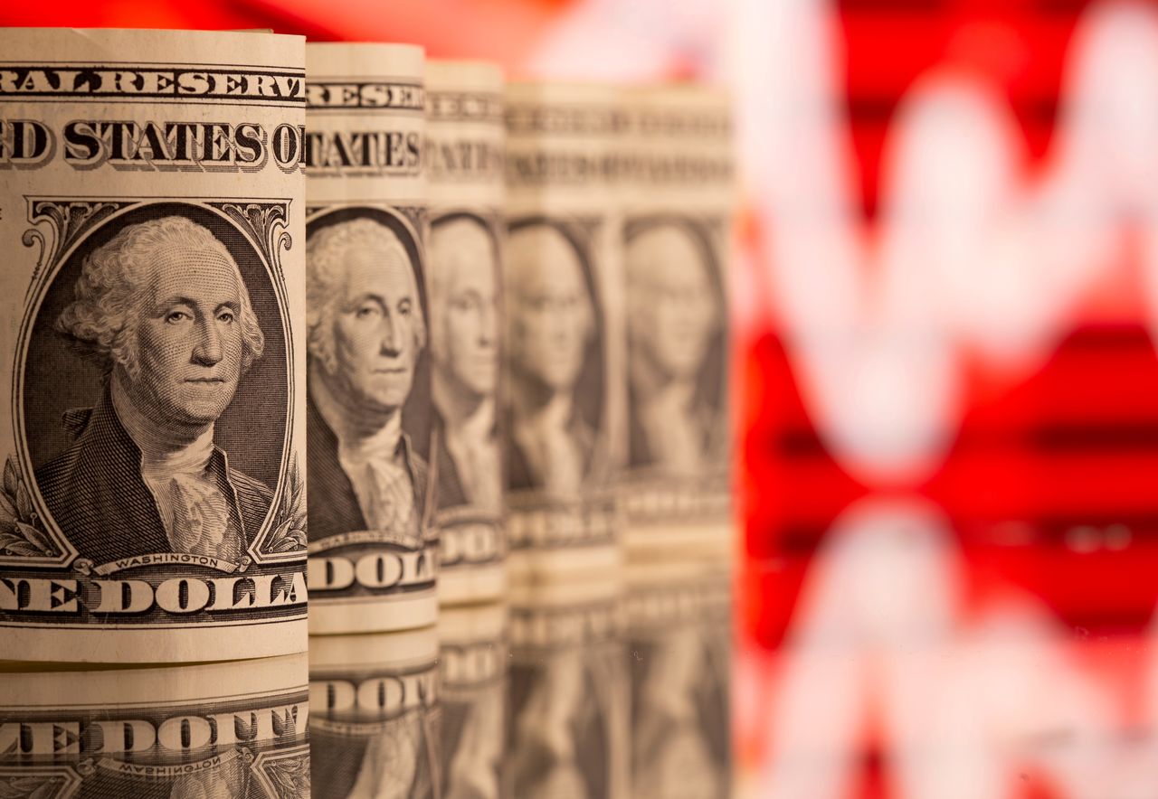 FILE PHOTO: U.S. One dollar banknotes are seen in front of displayed stock graph in this illustration taken, February 8, 2021. REUTERS/Dado Ruvic/Illustration//File Photo