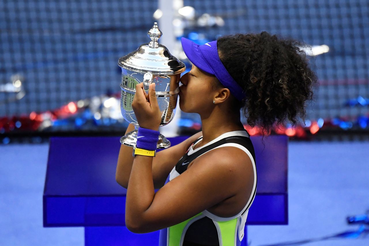 FILE PHOTO: Sep 12 2020; Flushing Meadows, New York, USA; Naomi Osaka of Japan celebrates with the championship trophy after her match against Victoria Azarenka of Belarus (not pictured) in the women