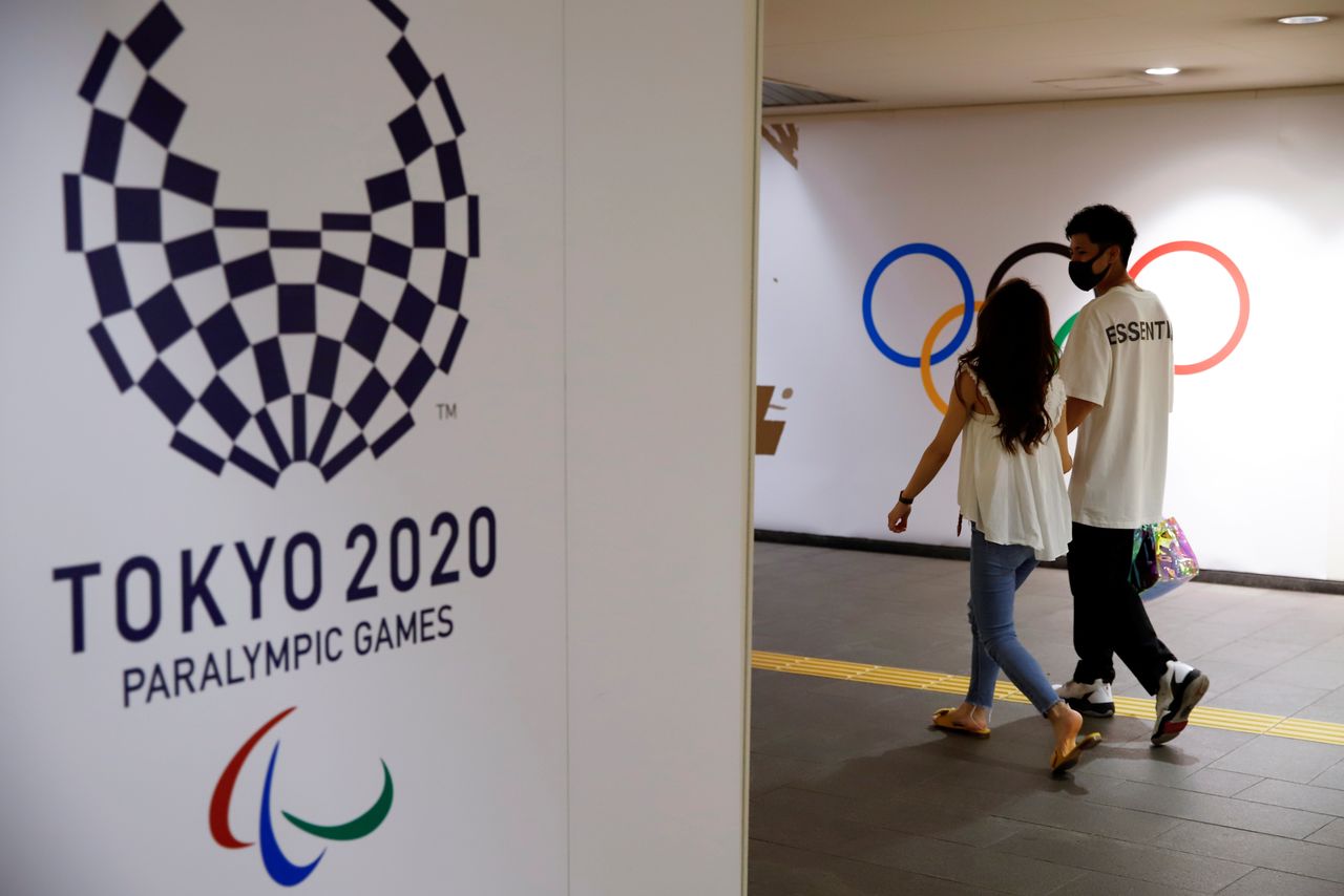 People walk by the Tokyo 2020 Paralympics logo at a metro station in Tokyo, Japan August 29, 2021. REUTERS/Androniki Christodoulou
