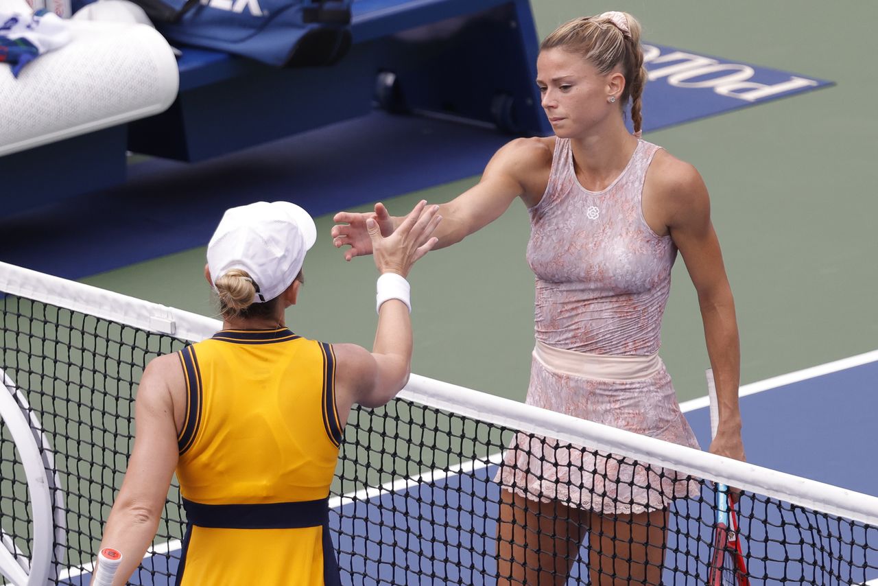 Aug 30, 2021; Flushing, NY, USA; Simona Halep (ROU) (L) shakes hand with Camila Giorgi (ITA) (R) after their match on day one of the 2021 U.S. Open tennis tournament at USTA Billie King National Tennis Center. Mandatory Credit: Geoff Burke-USA TODAY Sports