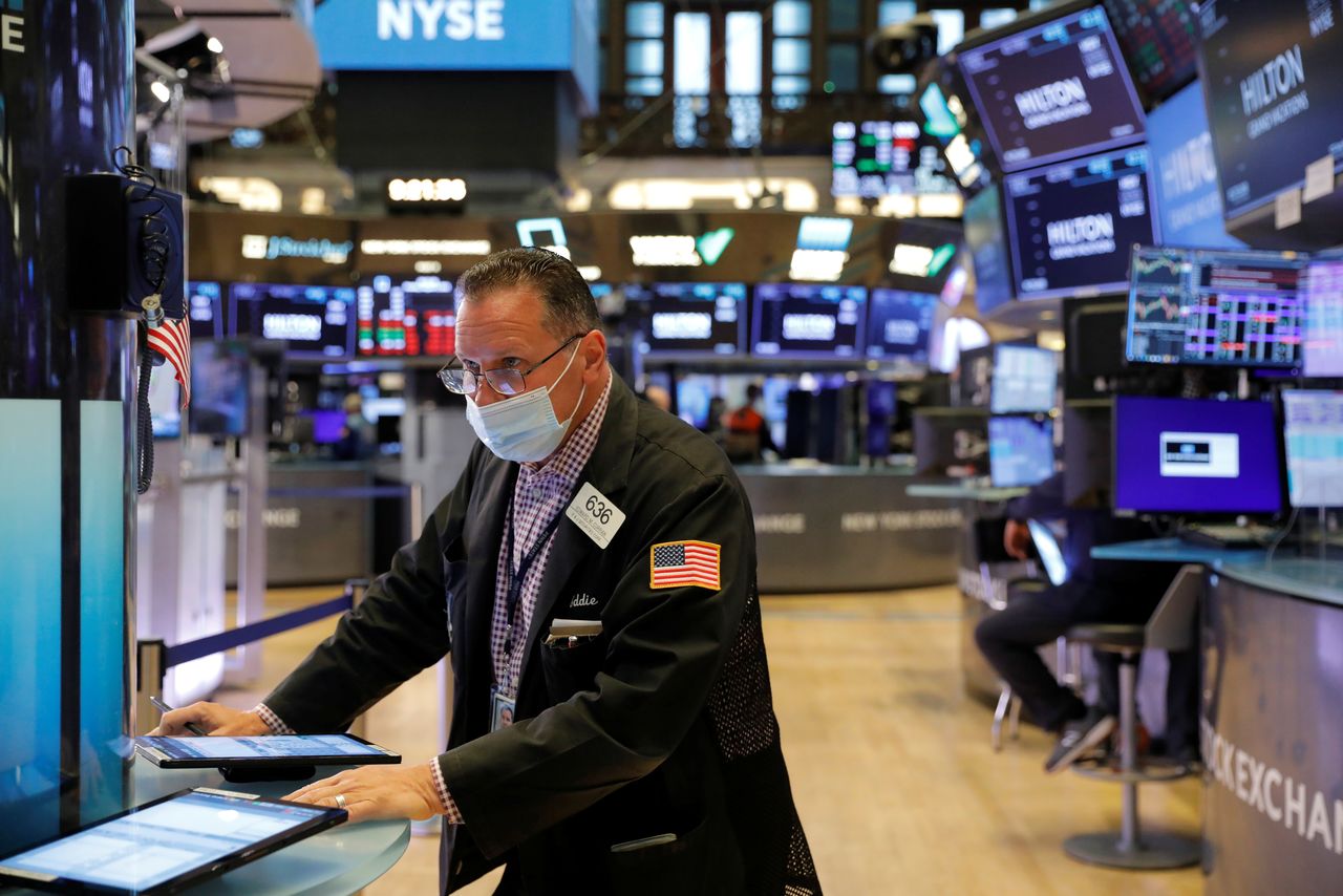 A trader works on the trading floor at the New York Stock Exchange (NYSE) in Manhattan, New York City, U.S., August 9, 2021. REUTERS/Andrew Kelly