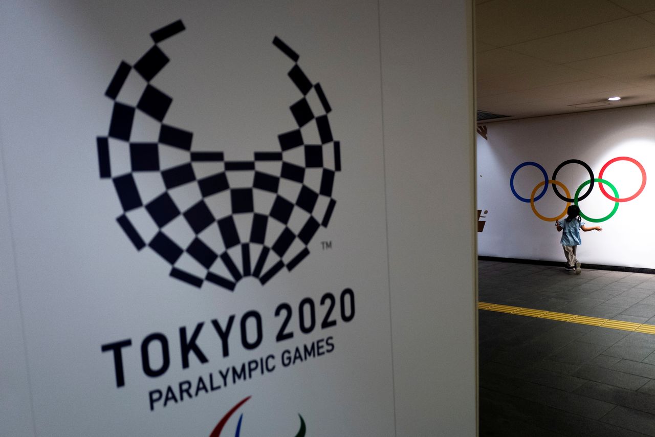 FILE PHOTO: A girl runs past Olympic rings and the logo of Tokyo 2020 Paralympic Games amid the coronavirus disease (COVID-19) pandemic in Tokyo, Japan, August 16, 2021. Picture taken August 16, 2021. REUTERS/Athit Perawongmetha/File Photo