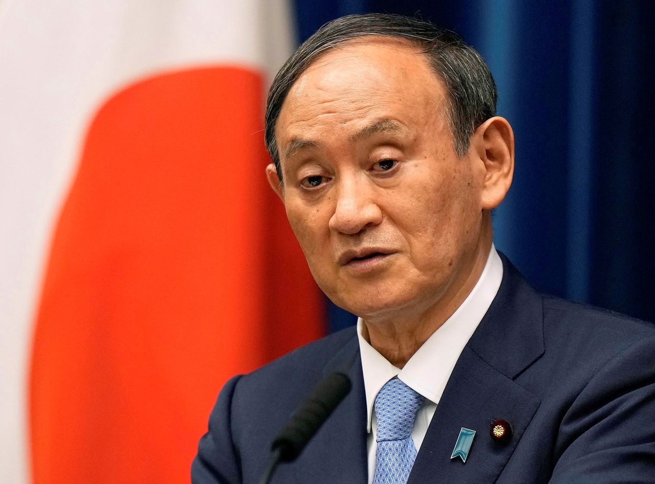 FILE PHOTO: Japanese Prime Minister Yoshihide Suga speaks during a news conference announcing to extend a state of emergency on COVID-19 pandemic at prime minister