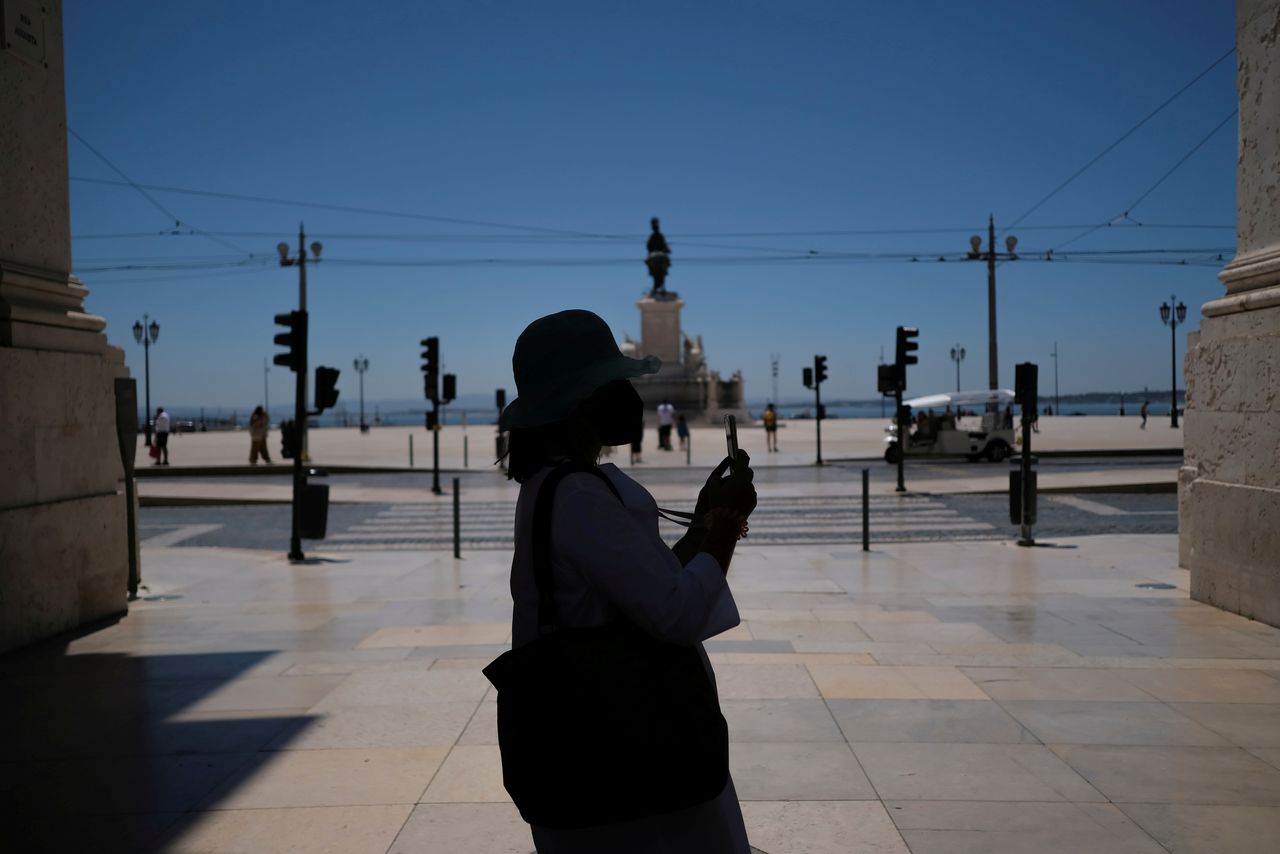 FILE PHOTO: A person takes a picture in Lisbon downtown amid the coronavirus disease (COVID-19) pandemic, in Lisbon, Portugal, June 24, 2021. REUTERS/Pedro Nunes