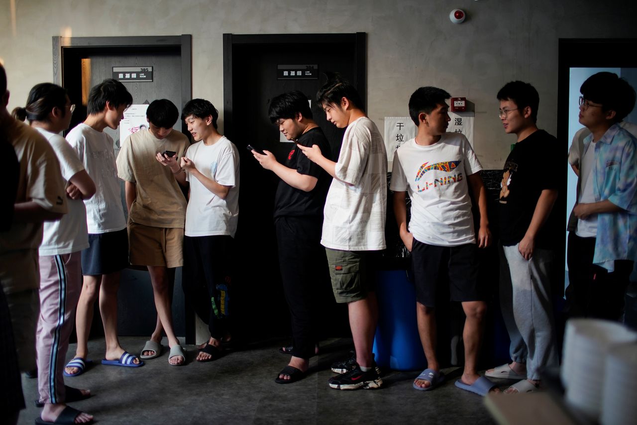 Rogue Warriors esports team members take a break before their dinner, in a cafeteria at their club in Shanghai, China September 3, 2021. Picture taken September 3, 2021. REUTERS/Aly Song