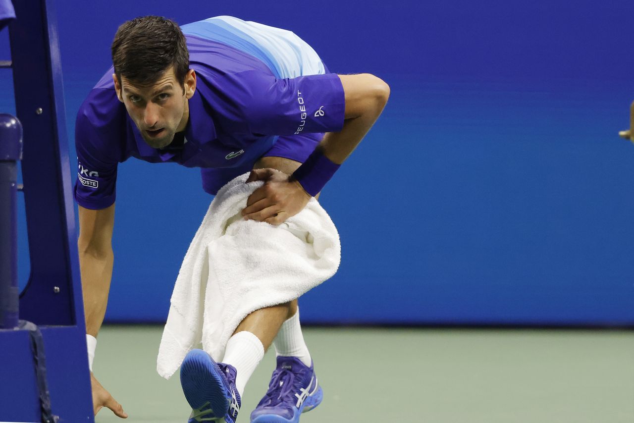 Sep 6, 2021; Flushing, NY, USA; Novak Djokovic of Serbia stretches during a changeover against Jenson Brooksby of the United States (not pictured) on day eight of the 2021 U.S. Open tennis tournament at USTA Billie Jean King National Tennis Center. Mandatory Credit: Geoff Burke-USA TODAY Sports