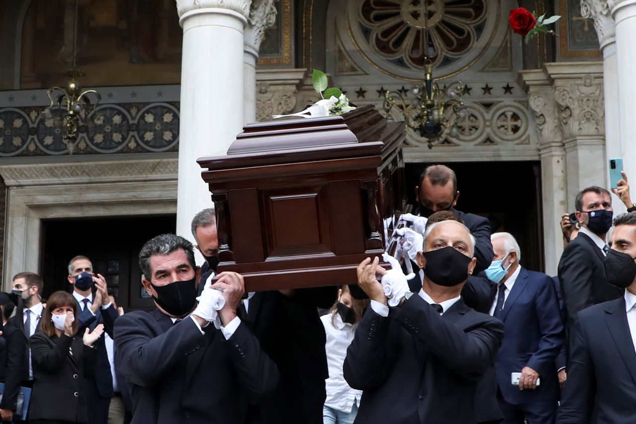 A rose is thrown over the coffin of Greek composer Mikis Theodorakis following a farewell ceremony at the Metropolitan Cathedral in Athens, Greece, September 8, 2021. REUTERS/Louiza Vradi