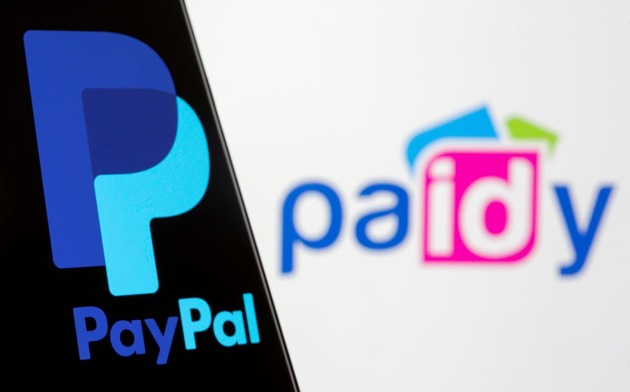 The PayPal logo is seen on a smartphone in front of a displayed Paidy logo in this illustration taken September 8, 2021. REUTERS/Dado Ruvic/Illustration