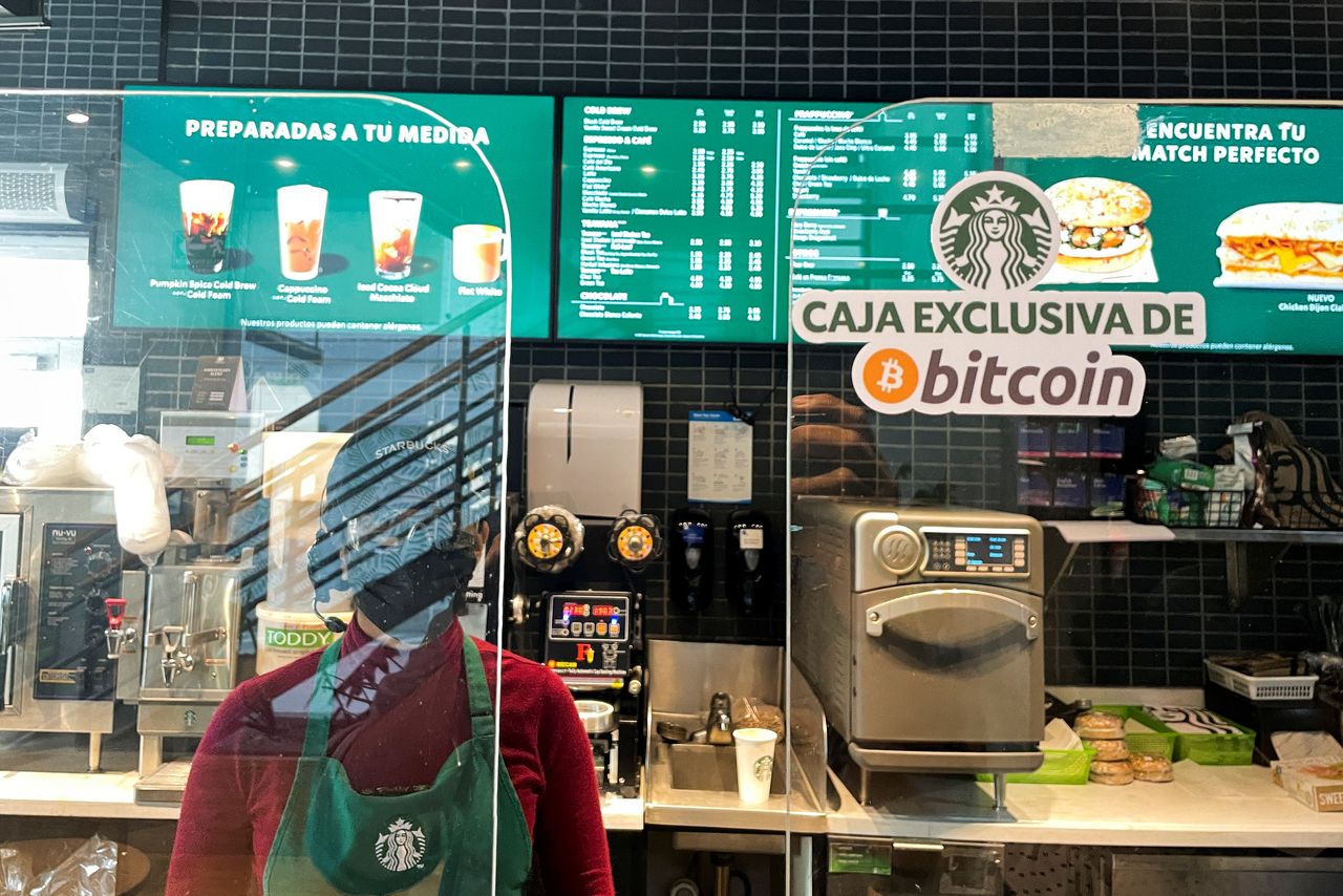 FILE PHOTO: A sign reads: "Exclusive Bitcoin register" in a Starbucks store where the cryptocurrency is accepted as a payment method, in San Salvador, El Salvador September 7, 2021. REUTERS/Jose Cabezas