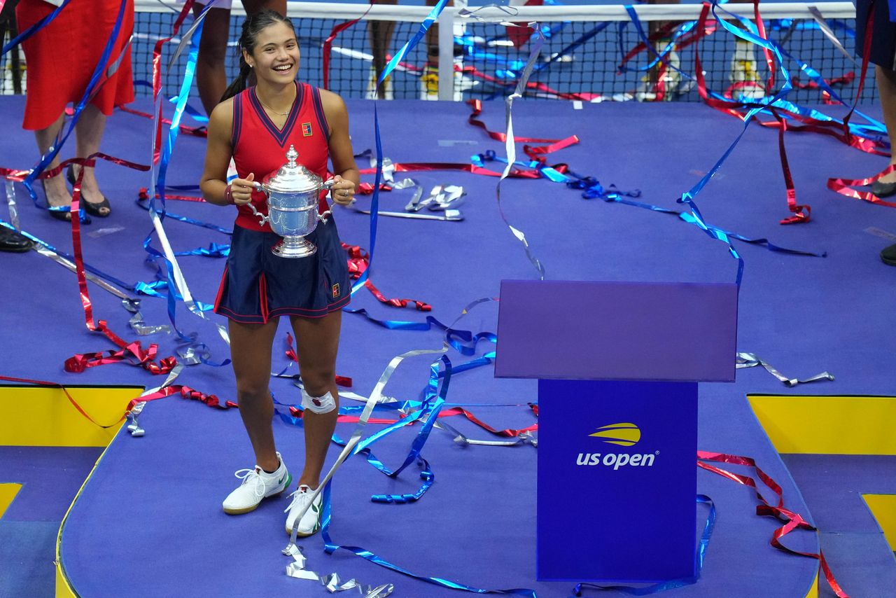 Sep 11, 2021; Flushing, NY, USA; Emma Raducanu of Great Britain celebrates with the championship trophy after her match against Leylah Fernandez of Canada (not pictured) in the women