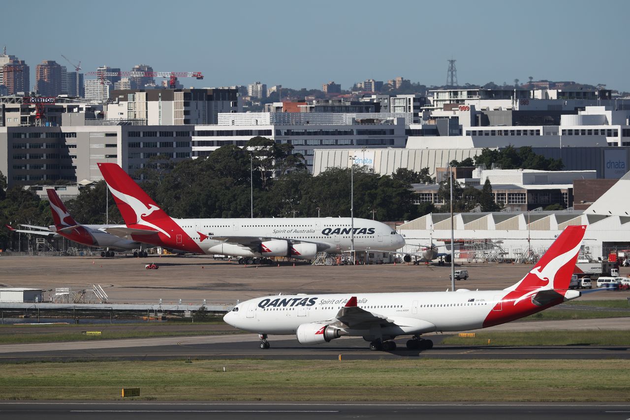 FILE PHOTO: Qantas planes are seen at Kingsford Smith International Airport, following the coronavirus outbreak, in Sydney, Australia, March 18, 2020.  REUTERS/Loren Elliott