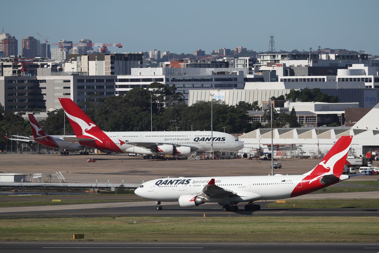 FILE PHOTO: Qantas planes are seen at Kingsford Smith International Airport, following the coronavirus outbreak, in Sydney, Australia, March 18, 2020. REUTERS/Loren Elliott