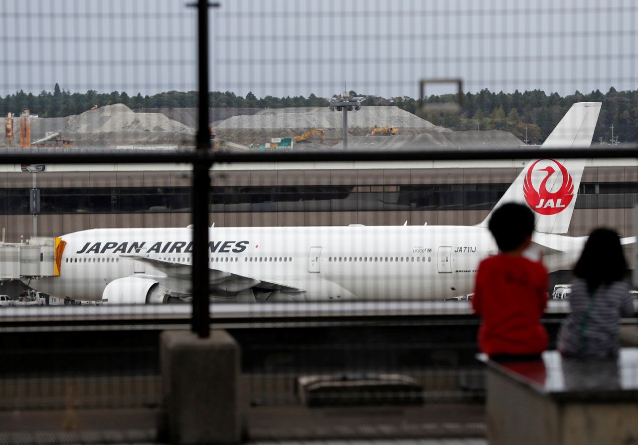 FILE PHOTO: A Japan Airlines (JAL) airplane is seen at Narita international airport, where there are fewer passengers than usual amid the coronavirus disease (COVID-19) outbreak, in Narita, east of Tokyo, Japan November 2, 2020. REUTERS/Issei Kato
