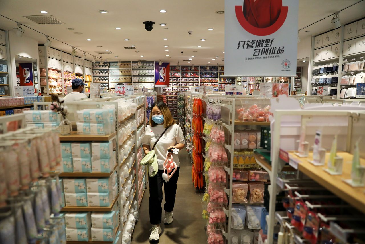 A customer shops at a store of Chinese retailer MINISO Group in Beijing, China September 13, 2021. REUTERS/Tingshu Wang