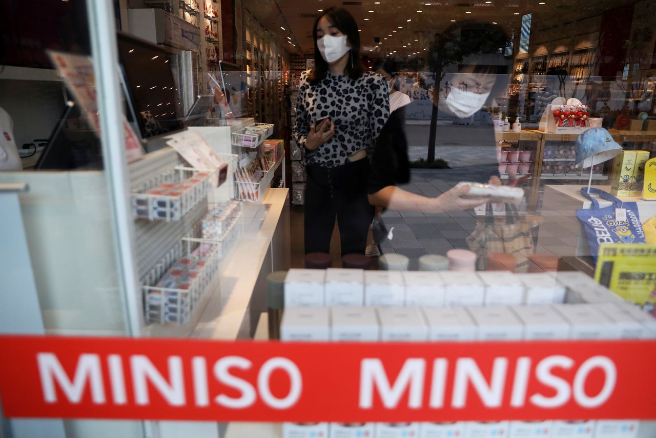 Customers shop at a store of Chinese retailer MINISO Group in Beijing, China September 13, 2021. REUTERS/Tingshu Wang