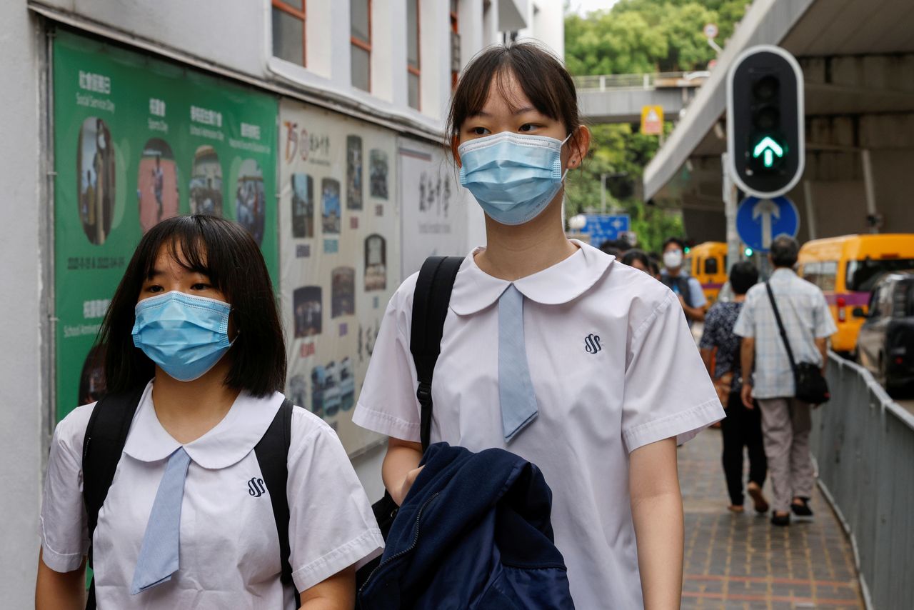 Secondary school students wear face masks as they walk to school on the first day of the new term in Hong Kong, China September 1, 2021. Picture taken September 1, 2021. REUTERS/Tyrone Siu