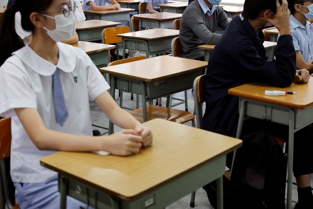 FILE PHOTO: Empty seats are seen inside a classroom of a secondary school at the first day of the new term in Hong Kong, China September 1, 2021. REUTERS/Tyrone Siu/File Photo