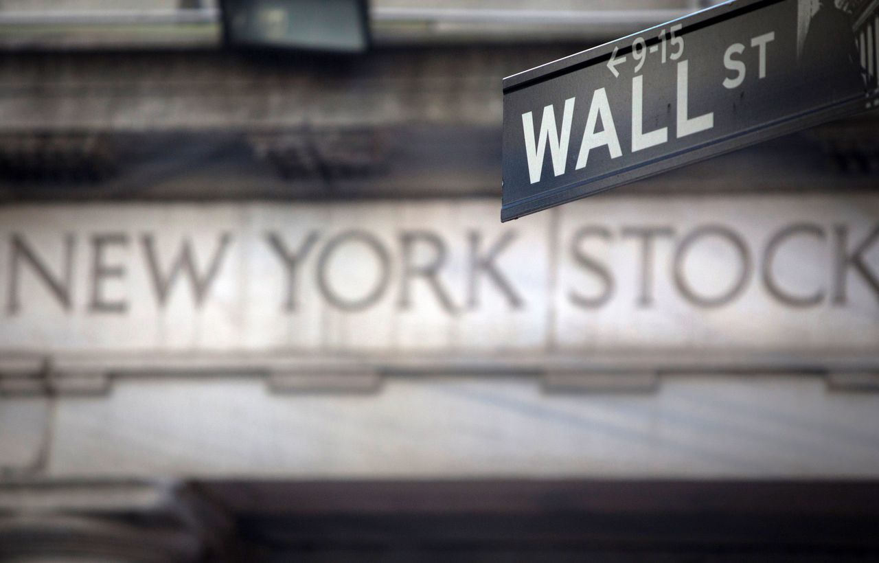 FILE PHOTO: A Wall Street sign is pictured outside the New York Stock Exchange in New York, October 28, 2013. REUTERS/Carlo Allegri/File Photo