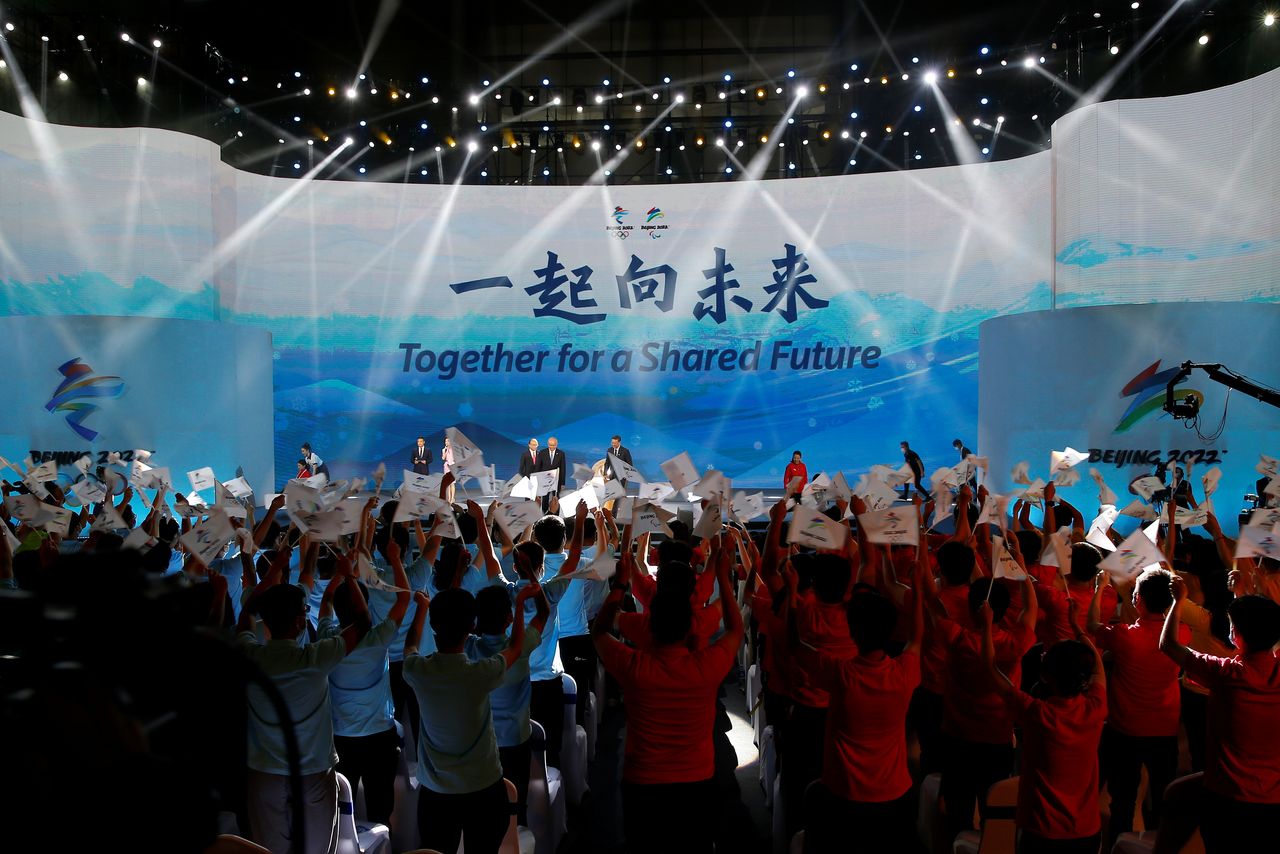 The slogan for the Beijing 2022 Winter Olympics, "Together for a shared future", is unveiled on a giant screen at a ceremony in Beijing, China September 17, 2021. REUTERS/Tingshu Wang