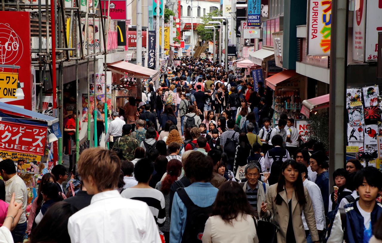 FILE PHOTO: People walk on a street in a busy shopping district in Tokyo, Japan May 17, 2017. REUTERS/Toru Hanai/File Photo