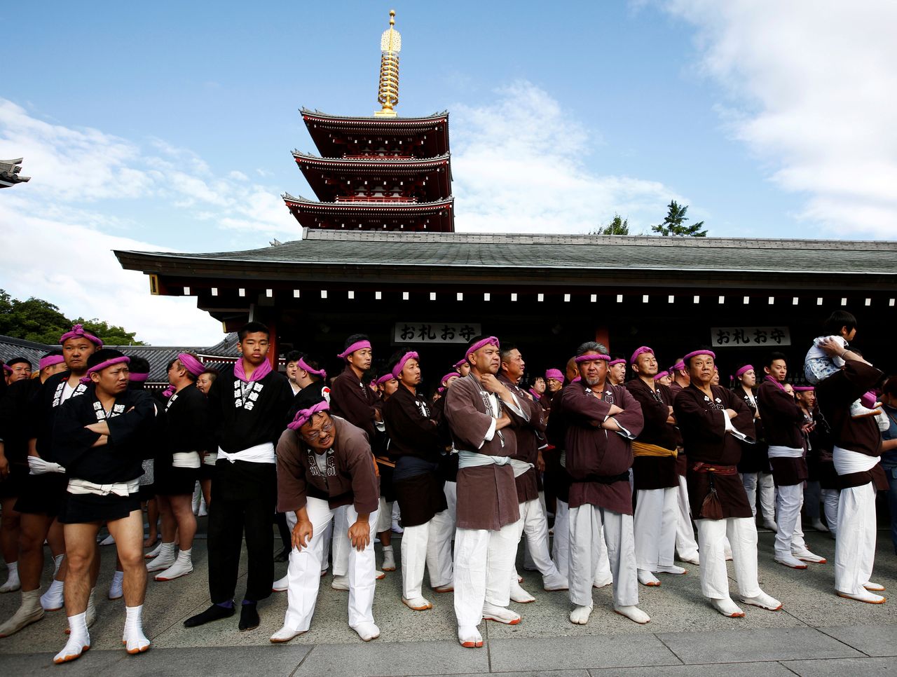 FILE PHOTO: People wait their turns to carry a portable shrine, a Mikoshi, at the Senso-ji Temple during the Sanja festival in Asakusa district in Tokyo, Japan, May 20, 2018. REUTERS/Kim Kyung-Hoon/File Photo