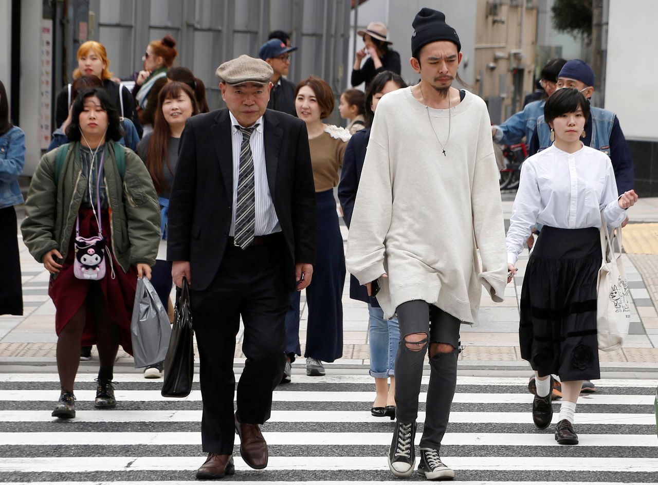 FILE PHOTO: Pedestrians cross the street at a crosswalk at Omotesando shopping district in Tokyo, Japan March 15, 2018. REUTERS/Kim Kyung-Hoon/File Photo