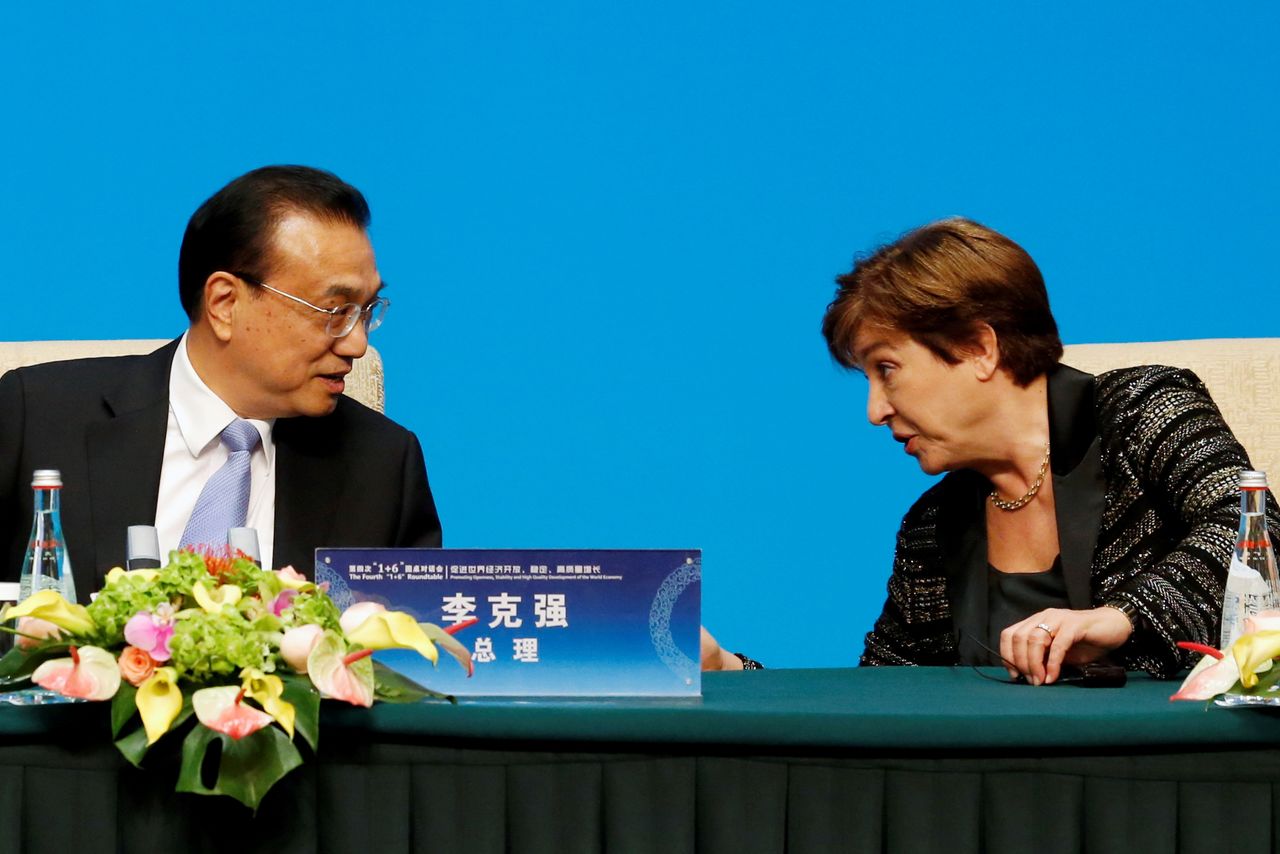 FILE PHOTO: International Monetary Fund (IMF) Managing Director Kristalina Georgieva talks to Chinese Premier Li Keqiang before a news conference following the "1+6" Roundtable meeting at the Diaoyutai state guesthouse in Beijing, China November 21, 2019. REUTERS/Florence Lo