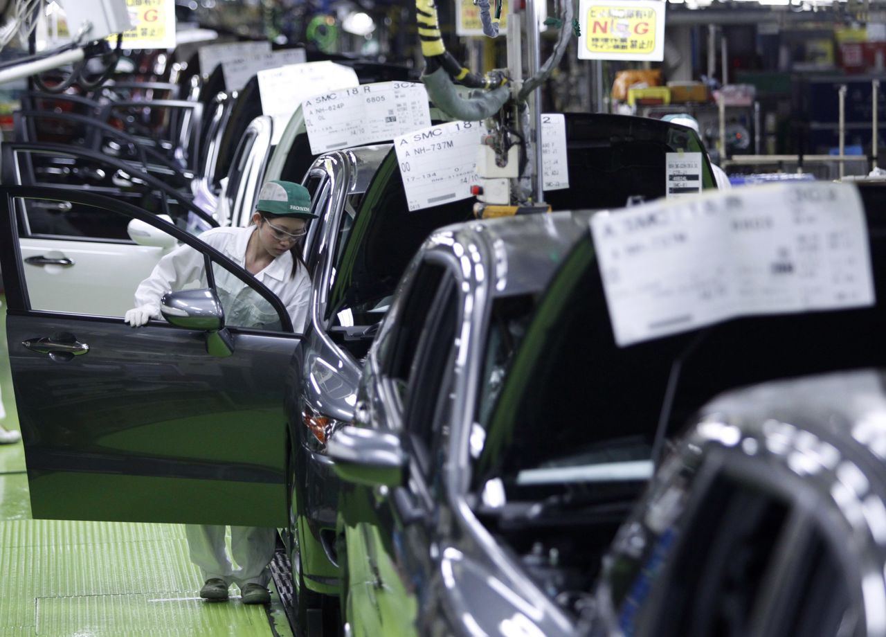 A worker assembles cars at Honda Motor