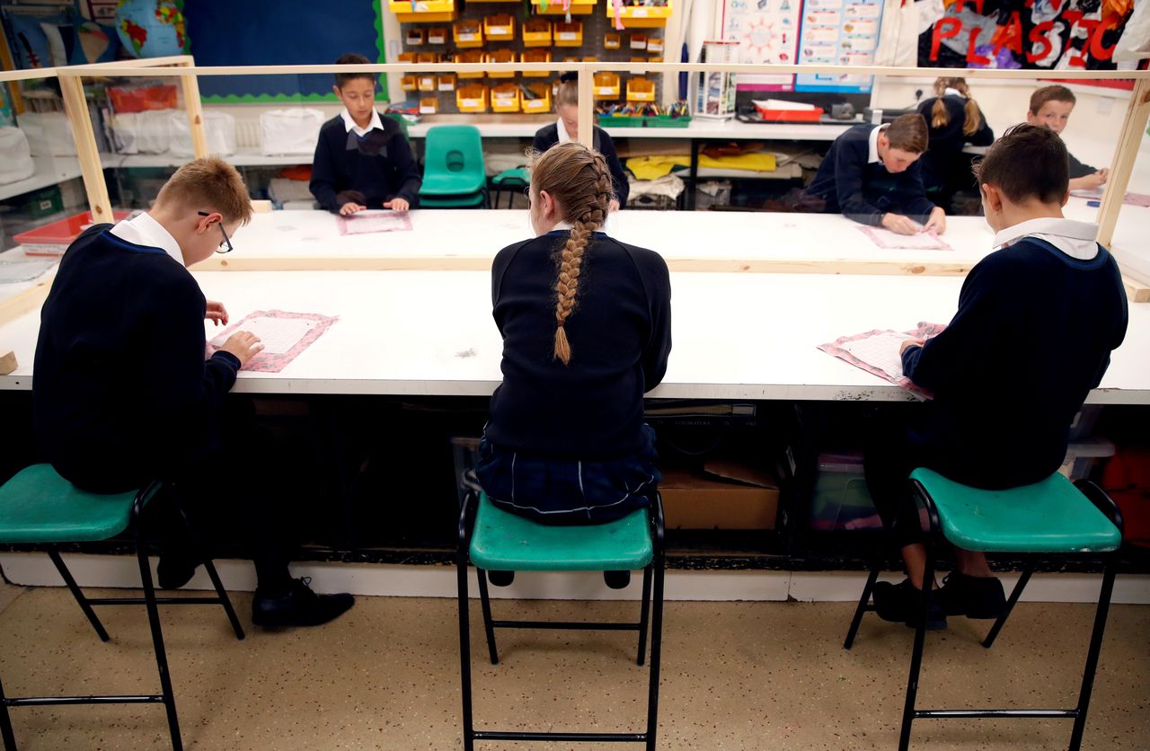 FILE PHOTO: Children sit in a classroom on their first day of school at Heath Mount, amid the outbreak of the coronavirus disease (COVID-19), in Watton at Stone, Britain September 3, 2020. REUTERS/Andrew Couldridge