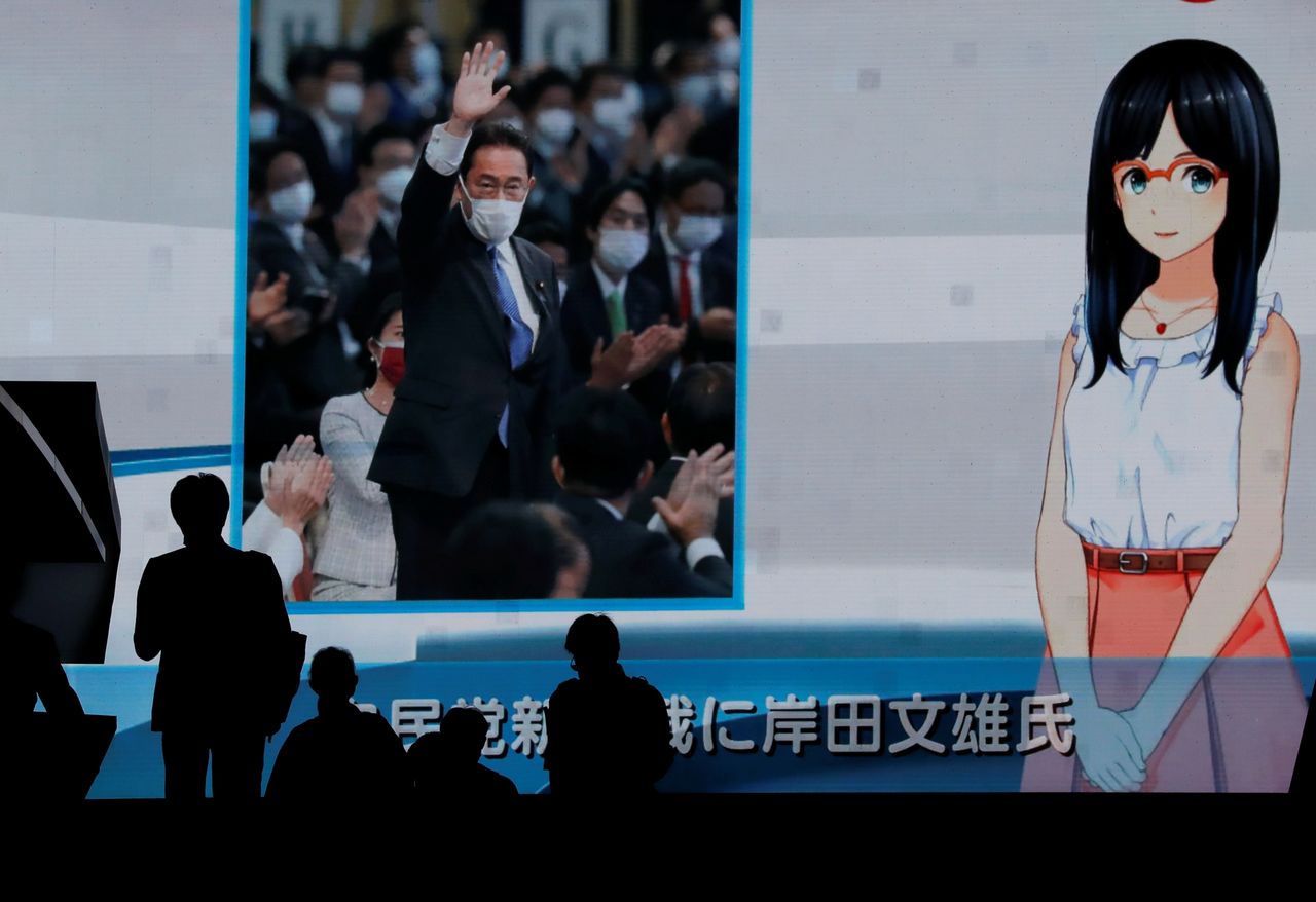 Passers-by are silhouetted as they walk past a screen reporting on former Japanese Foreign Minister Fumio Kishida winning the ruling party