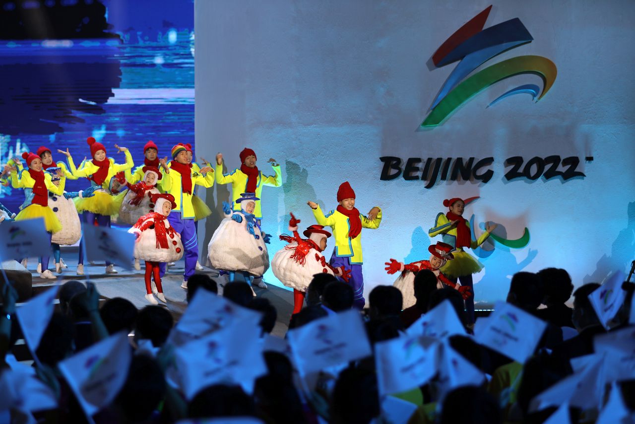 FILE PHOTO-Performers dance near an emblem of the Beijing Paralympic Winter Games, at a ceremony unveiling the slogan in Beijing, China September 17, 2021. REUTERS/Tingshu Wang
