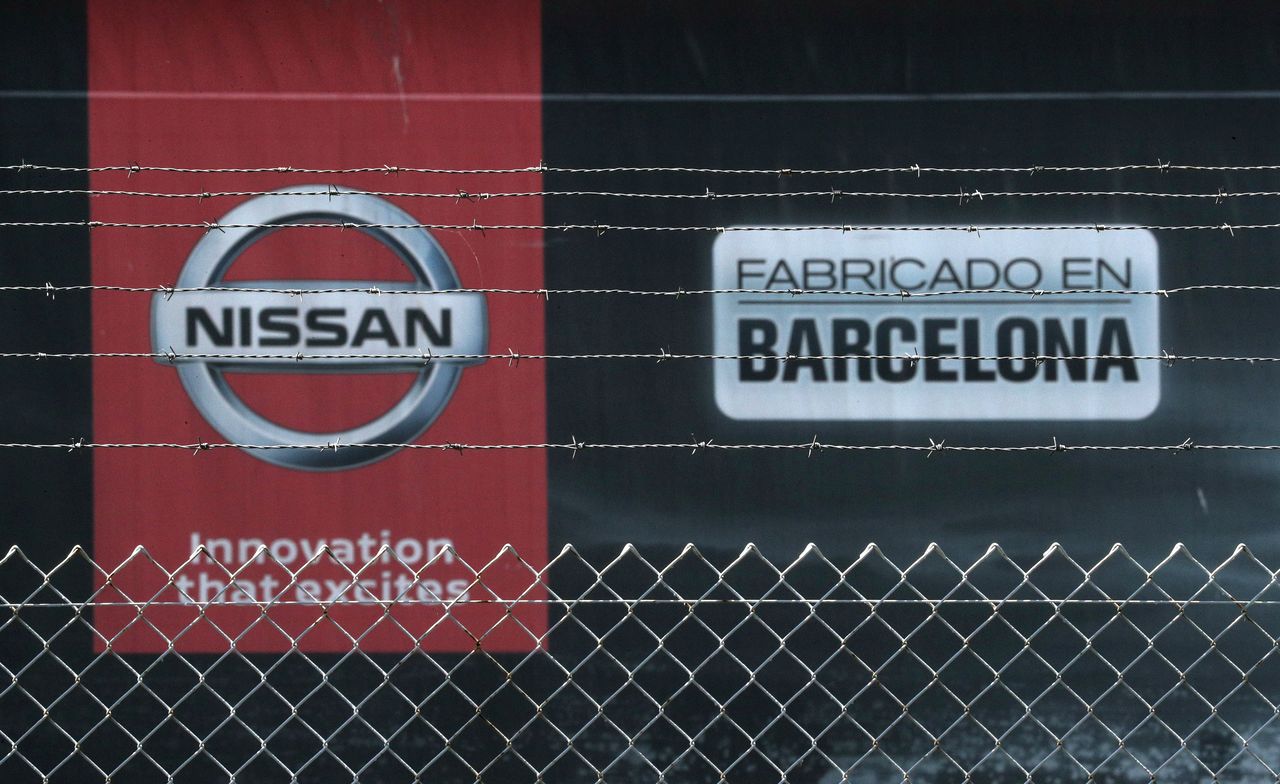 FILE PHOTO: The logo of Nissan is seen through a fence at Nissan factory at Zona Franca during the coronavirus disease (COVID-19) outbreak in Barcelona, Spain, May 26, 2020. REUTERS/Albert Gea/File Photo
