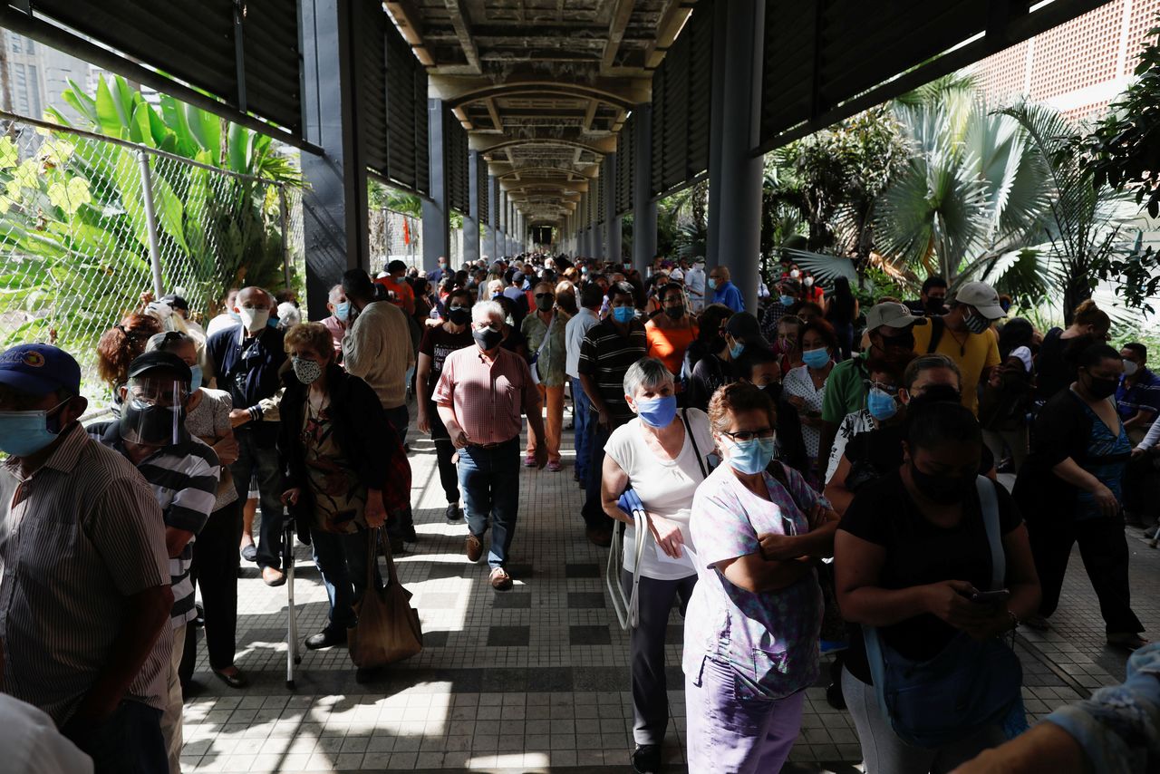 FILE PHOTO: People stand in lines seeking to receive their second dose of Russia