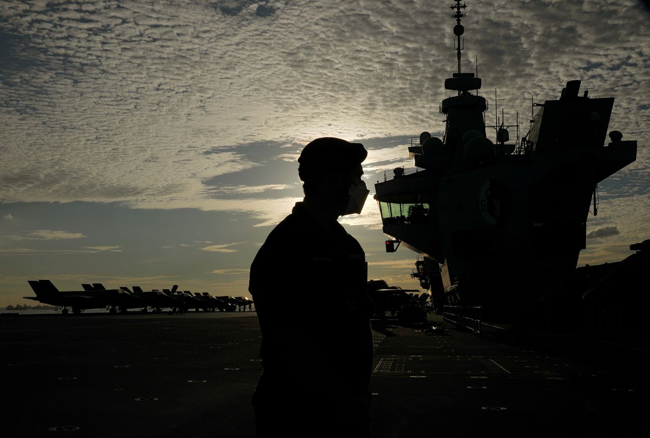 A member of navy personnel stands on the flight deck of Britain’s HMS Queen Elizabeth aircraft carrier at Changi Naval Base in Singapore October 11, 2021. REUTERS/Edgar Su