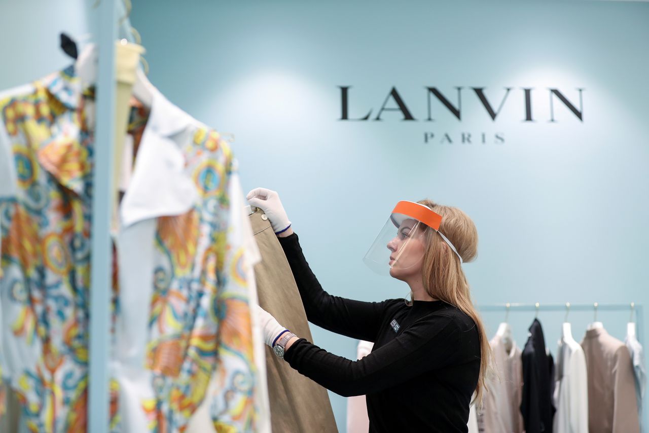 FILE PHOTO: A shop assistant wearing a protective mask, used as a preventive measure against coronavirus disease (COVID-19), works near the logo of Lanvin fashion company in the "TsUM" Central Universal Department Store in central Moscow, Russia March 26, 2020. REUTERS/Evgenia Novozhenina/File Photo