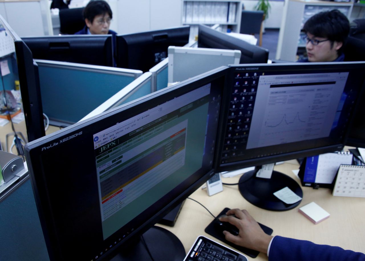 FILE PHOTO: Employees work at Japan Electric Power Exchange
