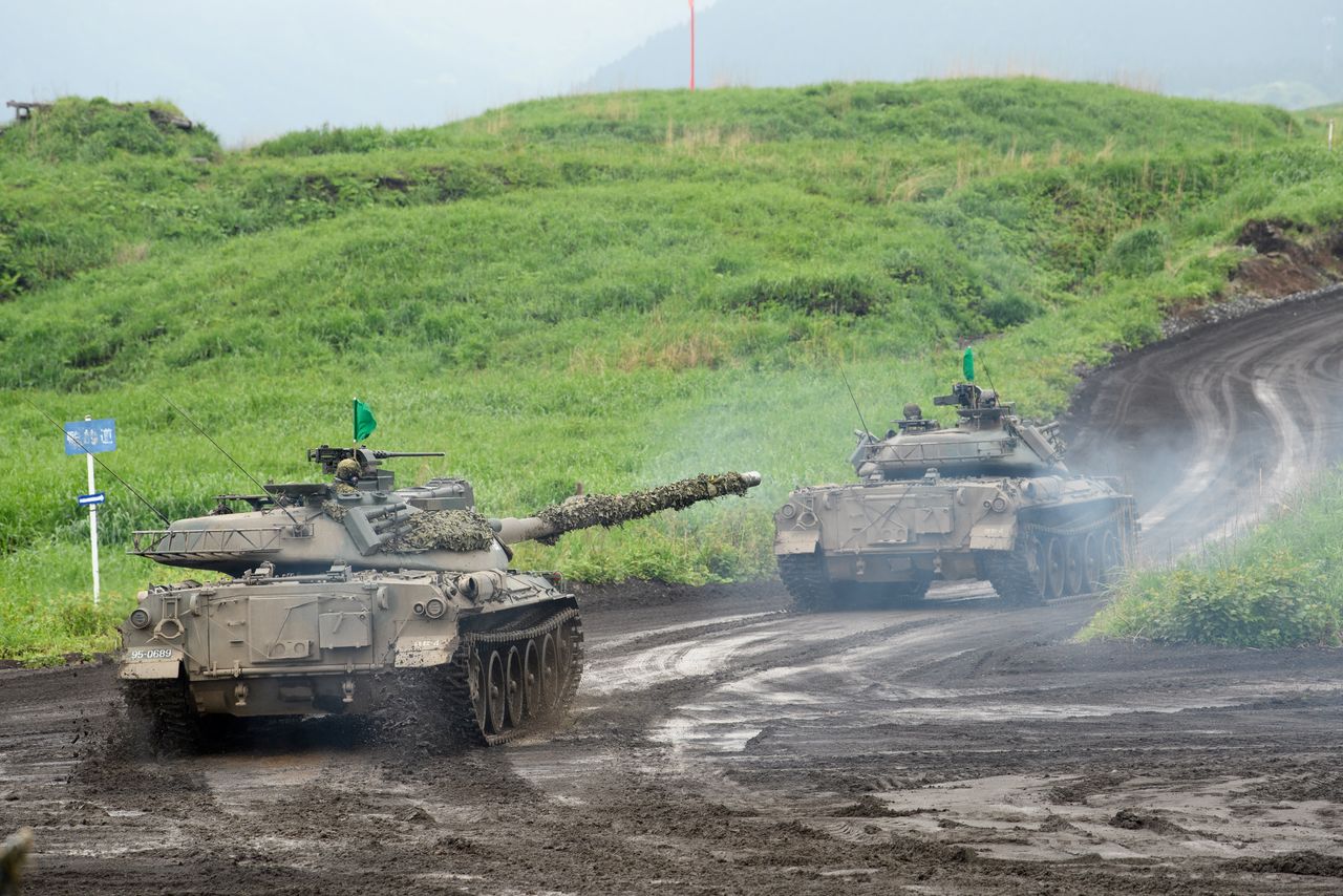 FILE PHOTO: Type-74 tanks move during a live fire exercise at Japan Ground Self-Defense Force