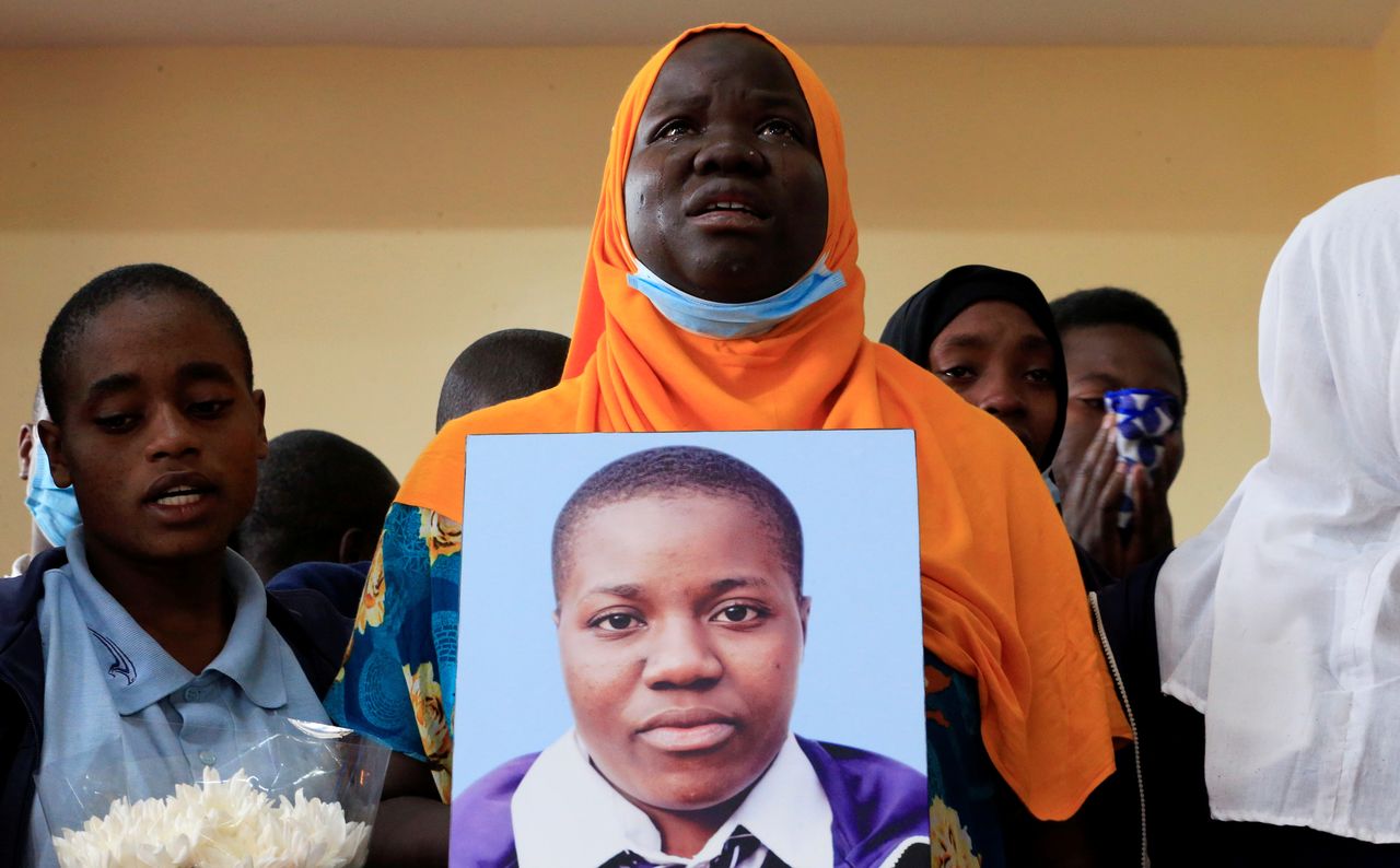 Dafida Hassan Yusuf, form four class teacher at the Kibera Girls School Soccer Academy (KGSA), reacts after attending the memorial service for Cynthia Makokha (on the photograph), a teenage student who was raped and killed as she travelled home for school holidays, in Kibera district of Nairobi, Kenya October 15, 2021. REUTERS/Thomas Mukoya