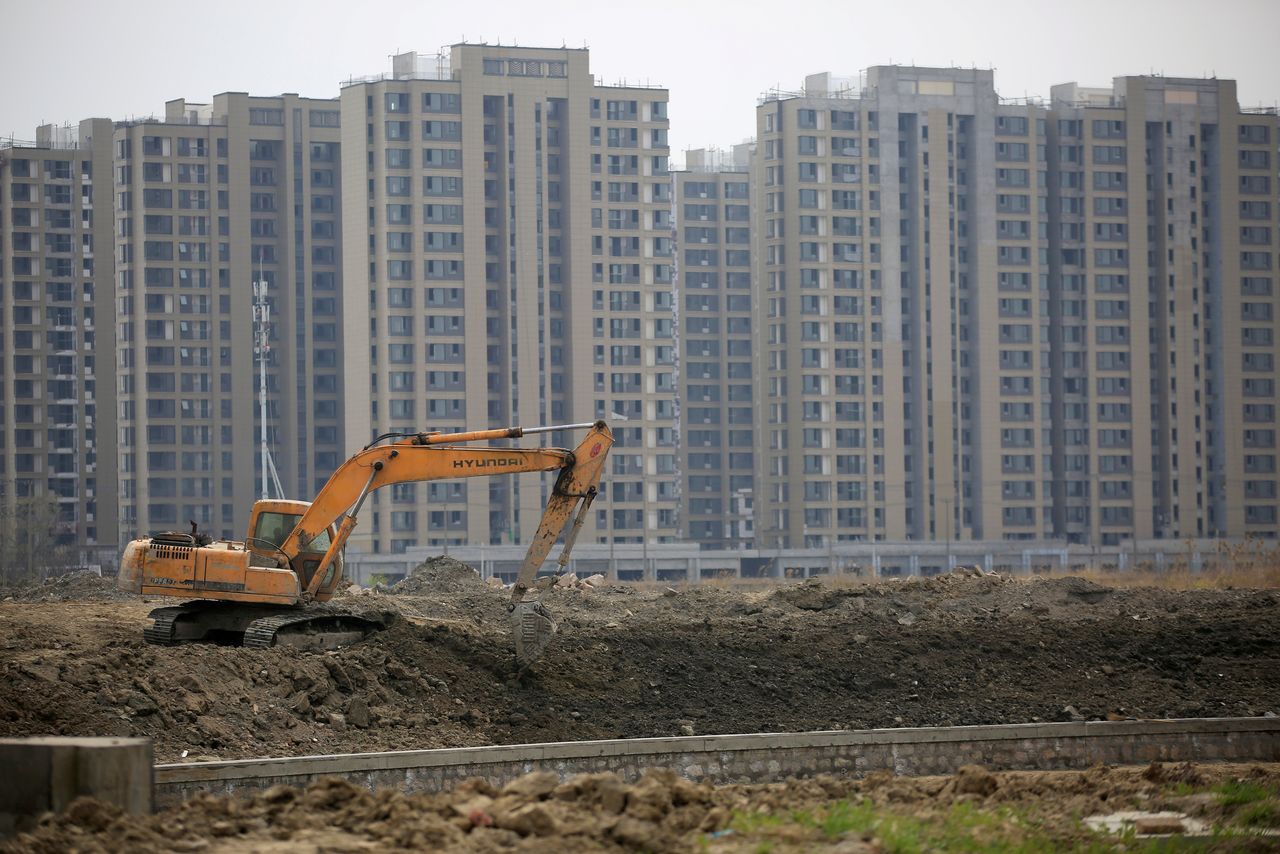 FILE PHOTO: An excavator is seen at a construction site of new residential buildings in Shanghai, China, in this March 21, 2016 file photo. REUTERS/Aly Song/File Photo