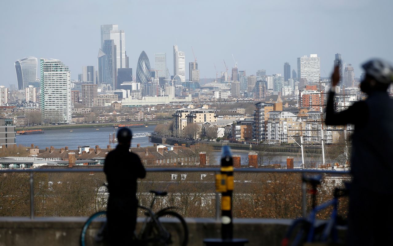 FILE PHOTO: Cyclists view the London skyline from Greenwich Park, London, Britain, March 29, 2020. REUTERS/Henry Nicholls