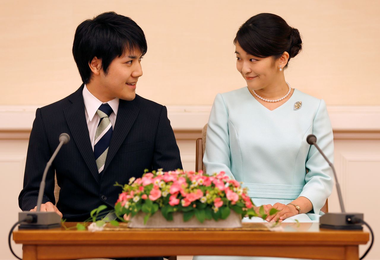 FILE PHOTO: Princess Mako, the elder daughter of Prince Akishino and Princess Kiko, and her fiancee Kei Komuro, a university friend of Princess Mako, smile during a press conference to announce their engagement at Akasaka East Residence in Tokyo, Japan, September 3, 2017. REUTERS/Shizuo Kambayashi/Pool/File Photo