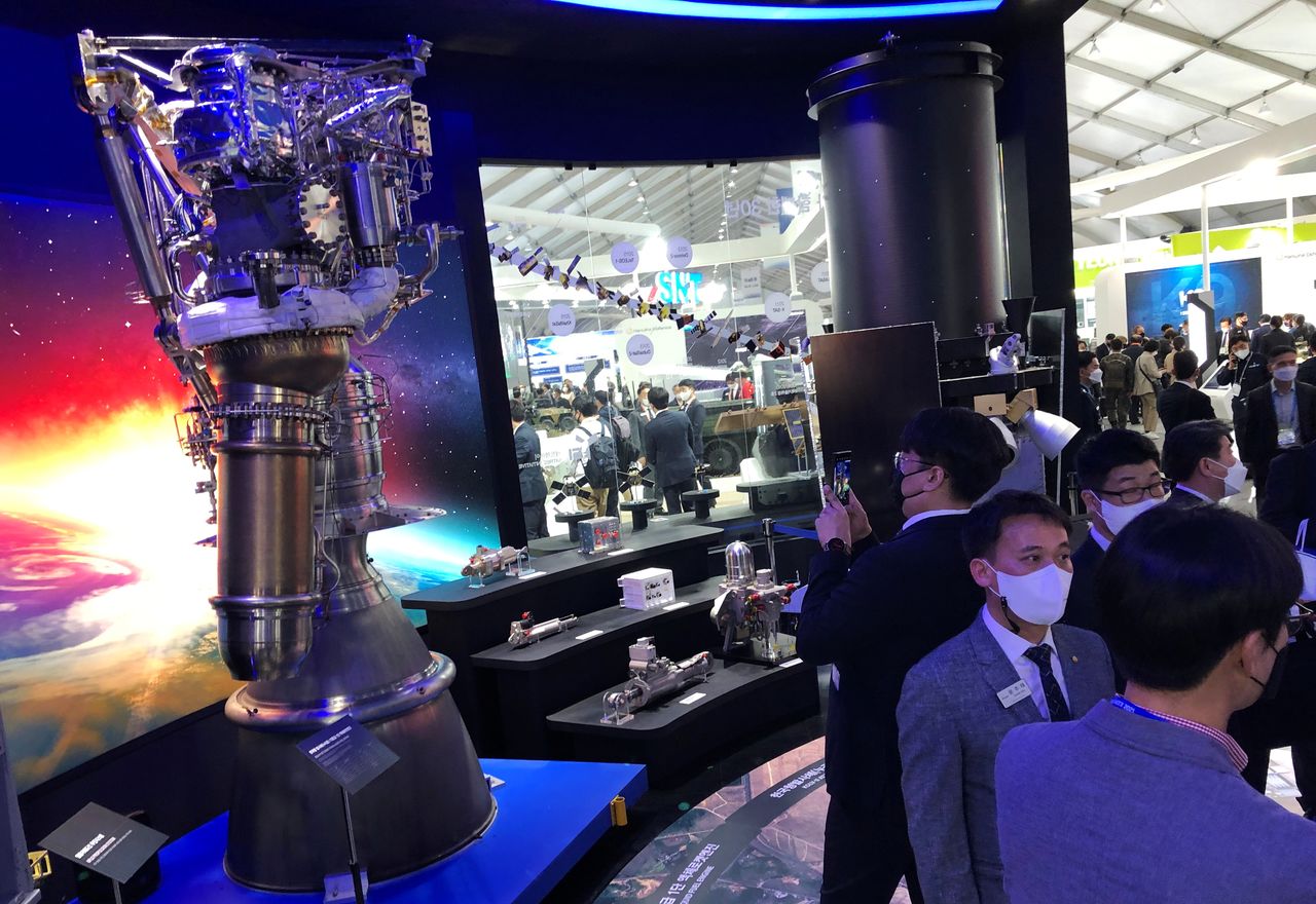 FILE PHOTO: Participants looks at a display of rocket engines and other components manufactured by Hanwha during the Seoul International Aerospace and Defense Exhibition (ADEX), in Seongnam, South Korea, October 20, 2021. REUTERS/Josh Smith